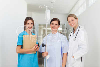 Doctor standing in a hallway with a patient and a nurse