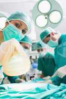 Focus on a nurse holding an anesthesia mask