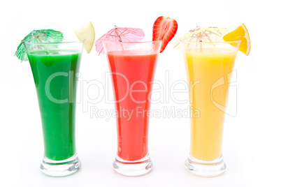 Fruit pieces and cocktail umbrella in a row of glasses