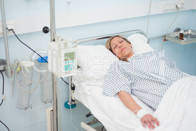 Woman lying on a medical bed with closed eyes