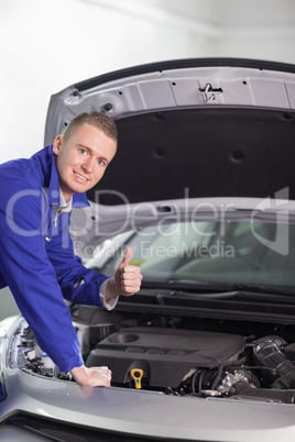 Mechanic with his thumb up while smiling
