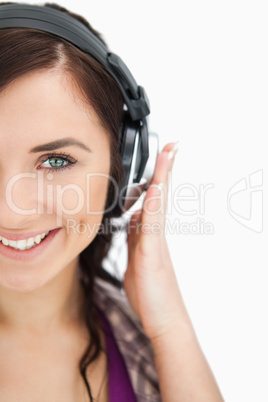 Blue eyed brunette smiling while wearing headphones