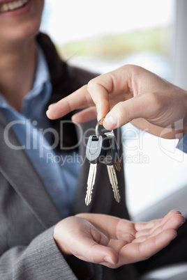 Woman smiling while receiving keys