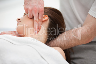 Doctor manipulating the neck of a woman while using his fingerti