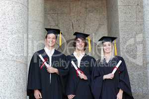 Portrait of graduates holding their diploma