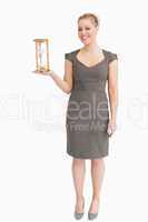 Woman holding a hourglass in her hand