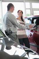 Salesman showing document to a woman