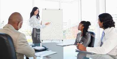 Three earnest employees attentively listening to a presentation