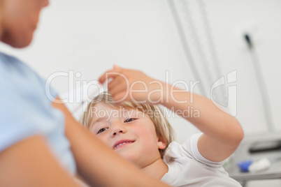 Mother receiving an injection by his child