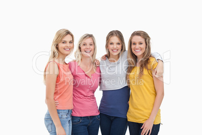 Four friends standing beside each other and smiling