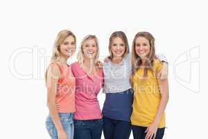 Four friends standing beside each other and smiling