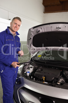 Mechanic holding a tablet computer