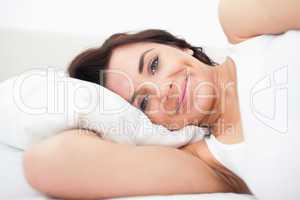 Smiling woman lying while waking up