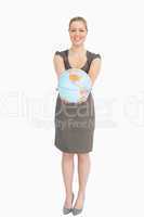 Woman smiling showing a globe