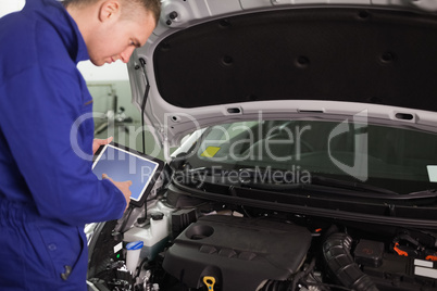 Mechanic using a tablet computer