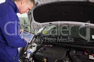 Mechanic using a tablet computer