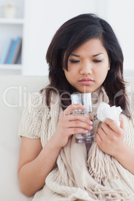 Sick woman holding a glass of water