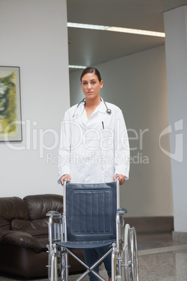 Doctor holding a wheelchair