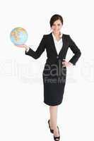 Happy businesswoman holding an earth globe