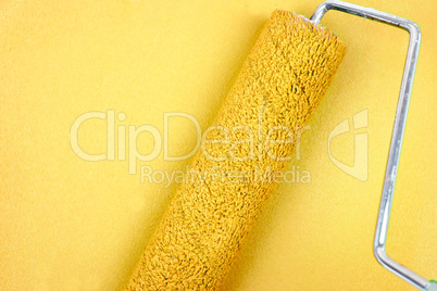 Yellow background with a paint roller