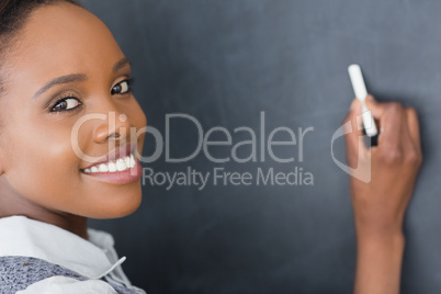 Close up of a teacher writing on a blackboard