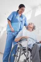 Elderly patient in a wheelchair next to a nurse