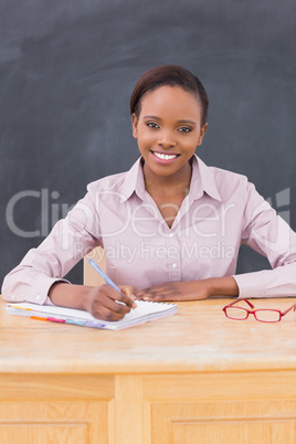 Teacher writing while smiling