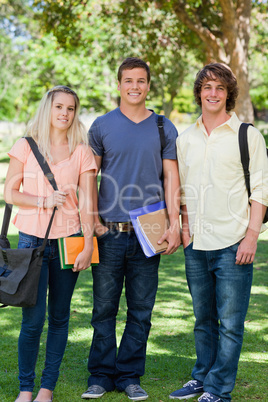 Three students posing side by side