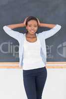 Black woman upset next to a blackboard