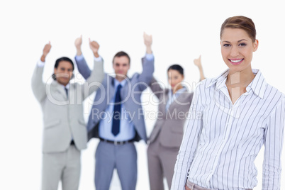 Close-up of a secretary smiling with enthusiastic business peopl