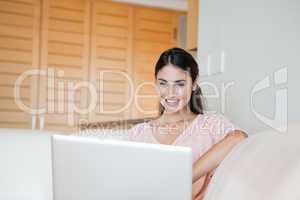Woman smiling while using a computer
