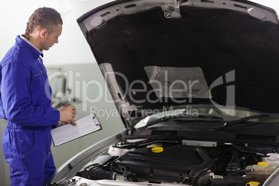 Mechanic holding a notepad