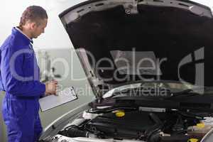 Mechanic holding a notepad