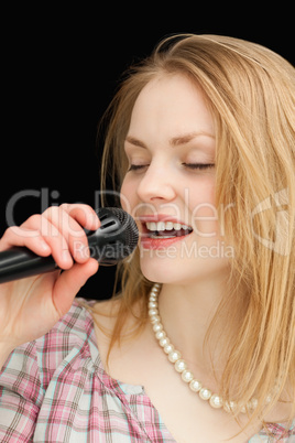 Woman singing while closing her eyes