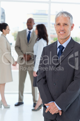 Serious manager standing upright with his hands crossed