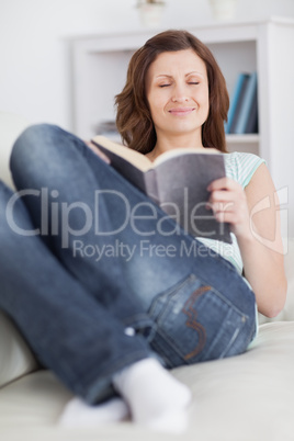 Woman closing her eyes while holding a book
