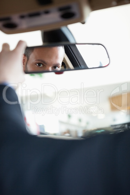 Man adjusting a rear view mirror