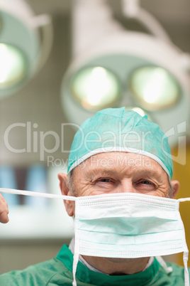 Close up of a surgeon putting on a surgical mask