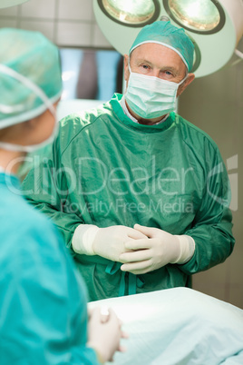 Two surgeons crossing their hands