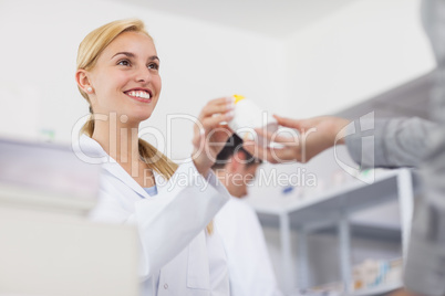 Pharmacist giving a drug box to a patient