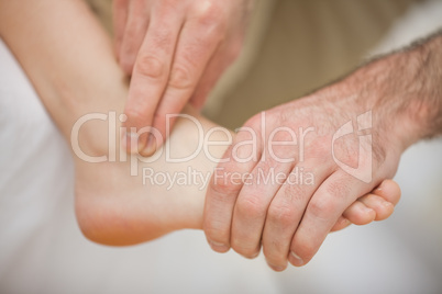 Physiotherapist massaging a barefoot