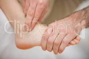 Physiotherapist massaging a barefoot