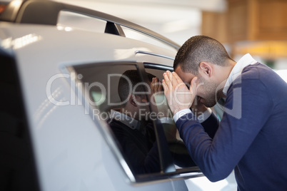 Client looking inside a car