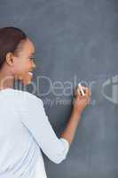 Black woman writing on a blackboard