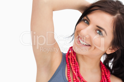 Smiling blue eyed woman posing with a red bead necklace