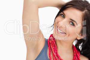 Smiling blue eyed woman posing with a red bead necklace