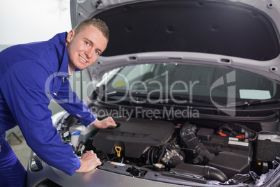 Smiling mechanic looking at camera