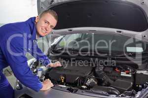 Smiling mechanic looking at camera