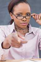 Strict black teacher pointing finger