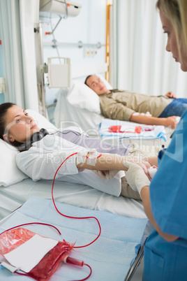 Nurse holding the arm of a patient